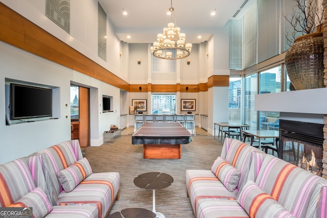860 Peachtree St Unit 1418, Atlanta, GA 30308 - playroom with carpet flooring, a high ceiling, an inviting chandelier, recessed lighting, and baseboards