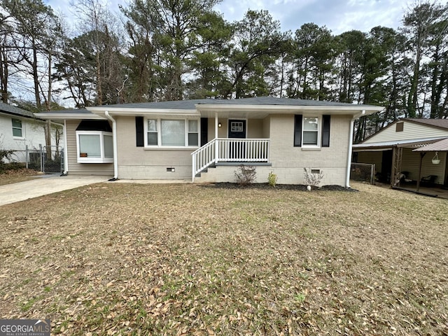 ranch-style home featuring crawl space, brick siding, a front lawn, and fence