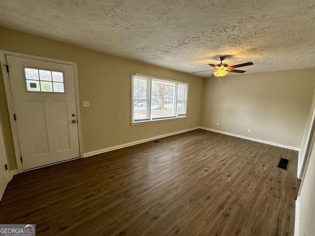 entryway with visible vents, baseboards, and dark wood-style floors