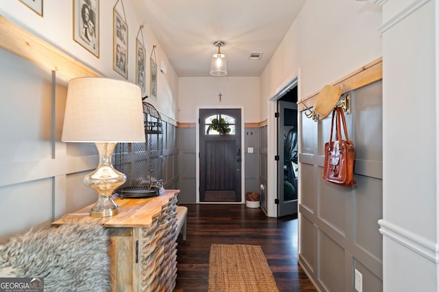 foyer entrance with visible vents and dark wood-type flooring