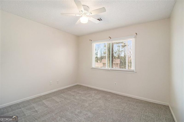 unfurnished room featuring baseboards, carpet floors, a textured ceiling, and a ceiling fan