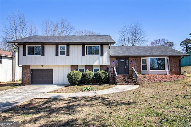 tri-level home featuring a garage, brick siding, and concrete driveway