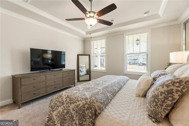 bedroom featuring baseboards, a raised ceiling, carpet, and crown molding