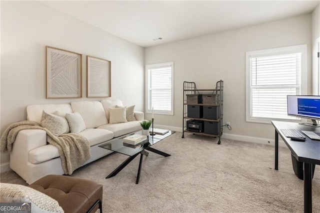 carpeted living area featuring baseboards