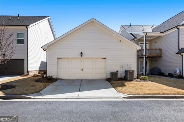 view of home's exterior with cooling unit, concrete driveway, and an attached garage