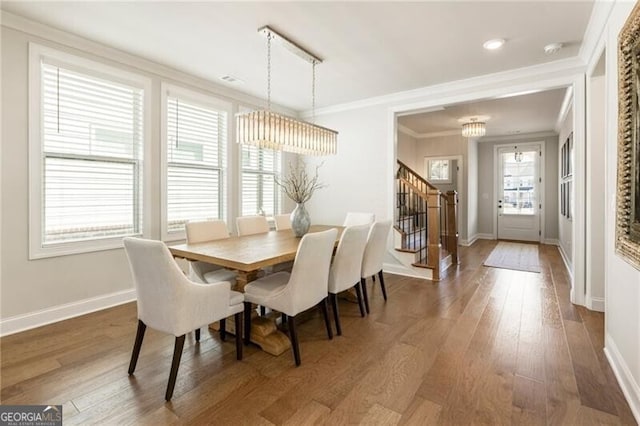 dining area featuring stairway, baseboards, dark wood-style flooring, and ornamental molding