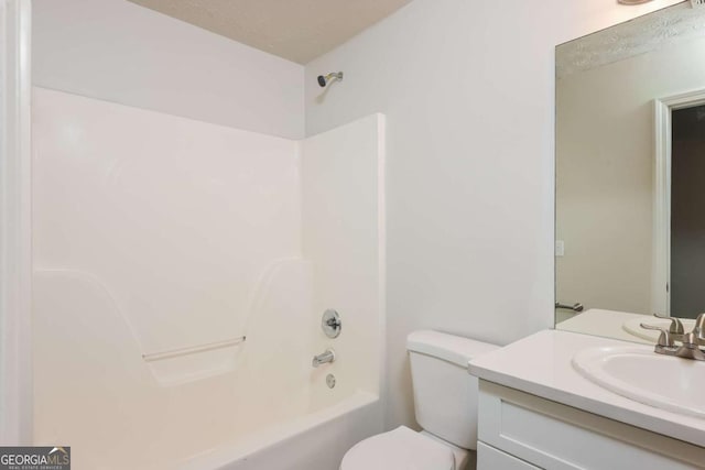 bathroom with vanity, toilet, and shower / washtub combination