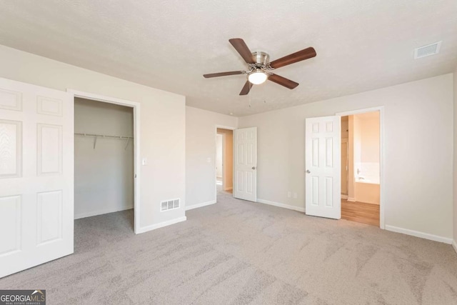 unfurnished bedroom featuring carpet, baseboards, and visible vents