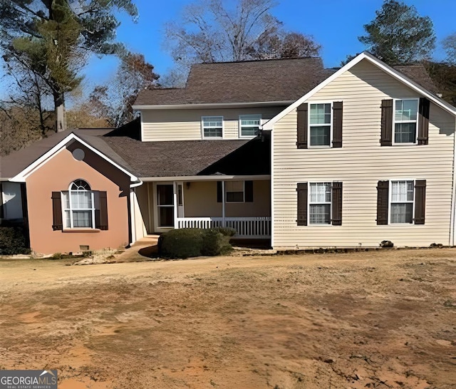 traditional-style home featuring a porch
