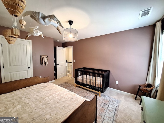 bedroom featuring visible vents, carpet flooring, and baseboards