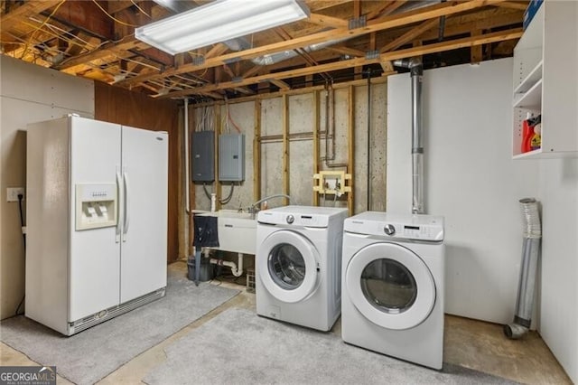 clothes washing area featuring electric panel, independent washer and dryer, laundry area, and a sink