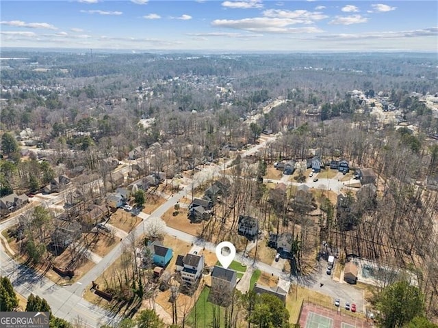 birds eye view of property featuring a wooded view