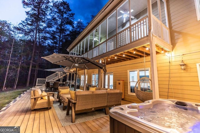 deck with an outdoor living space and a hot tub