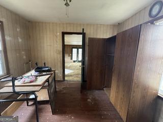 dining room with wood walls