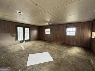 interior space featuring wooden walls and french doors