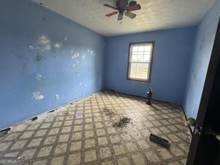 unfurnished room with ceiling fan