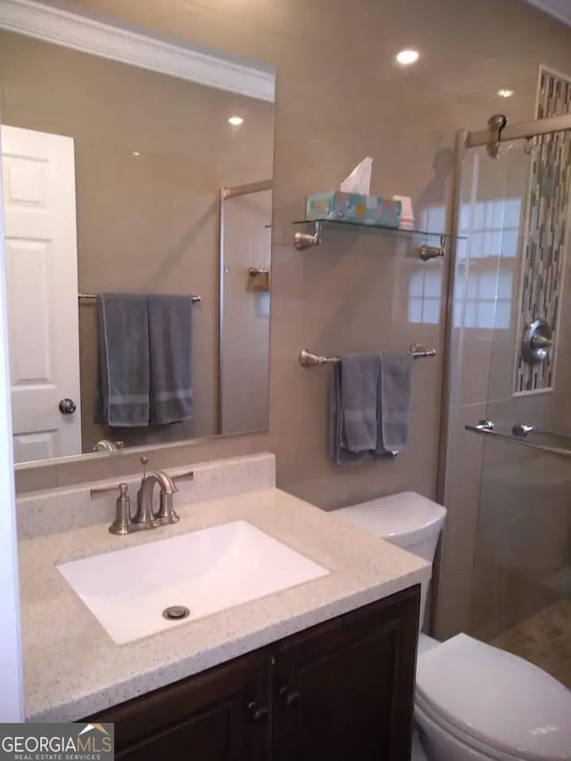 full bath with vanity, toilet, and a stall shower