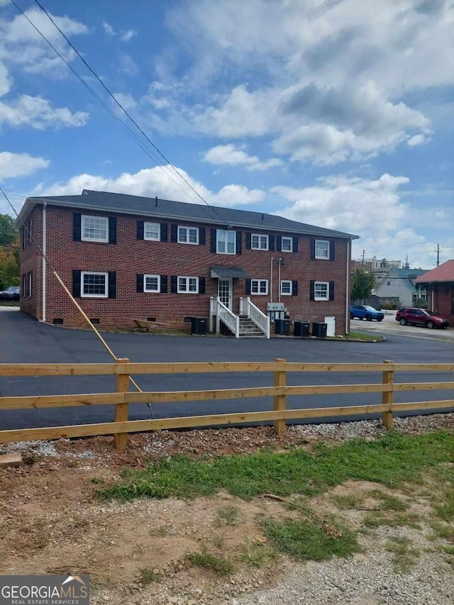 exterior space with central AC unit and fence