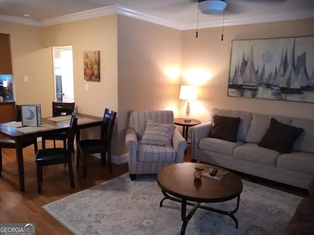 living area with wood finished floors, baseboards, and ornamental molding