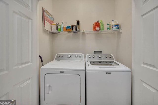 washroom featuring laundry area and washer and clothes dryer