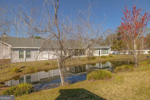 exterior space featuring a yard and a water view