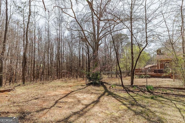 view of yard featuring fence and a view of trees