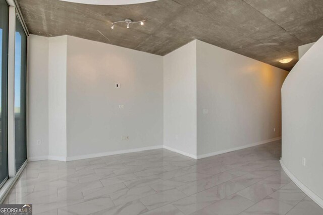 unfurnished room featuring visible vents, marble finish floor, baseboards, and ceiling fan