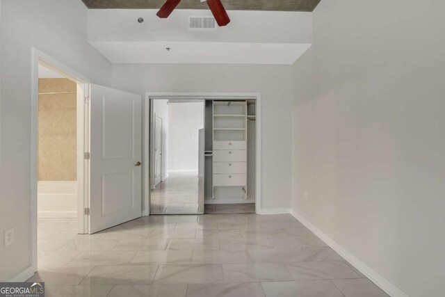 spare room with marble finish floor, baseboards, and a sink