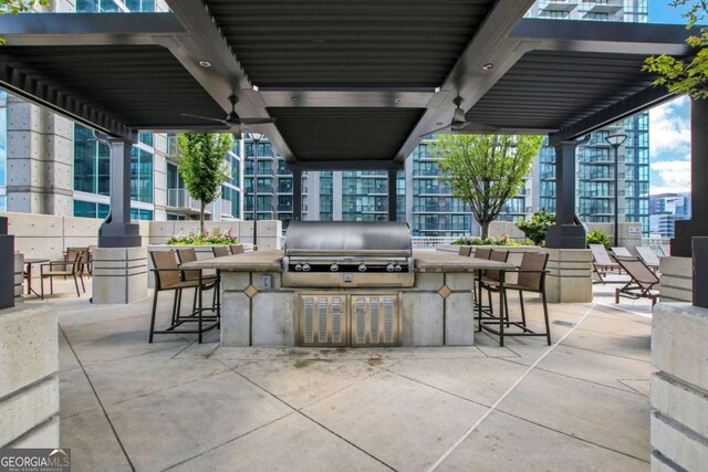 view of patio / terrace with a grill, exterior kitchen, and outdoor wet bar