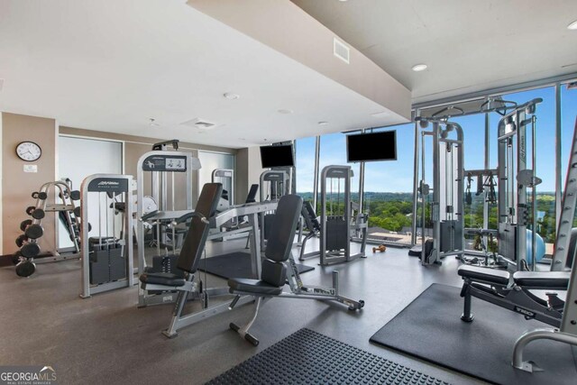 gym with recessed lighting, visible vents, and expansive windows