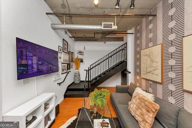 interior space featuring visible vents, stairway, track lighting, and wood finished floors