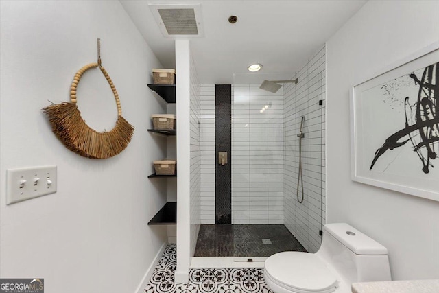 full bathroom featuring a shower stall, toilet, baseboards, and visible vents