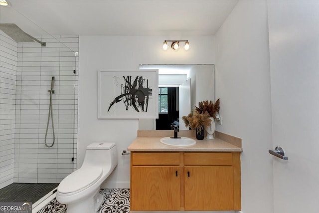 bathroom featuring vanity, toilet, and a tile shower