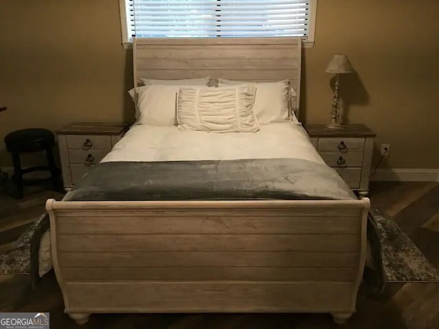 bedroom featuring multiple windows and baseboards