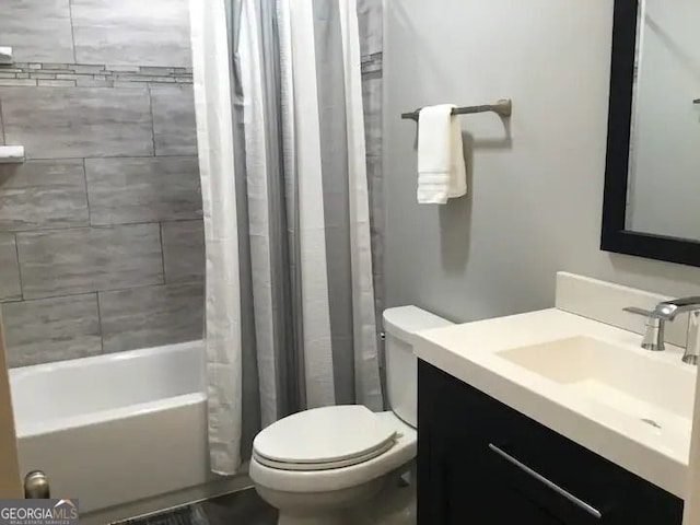 bathroom with vanity, shower / bath combination with curtain, and toilet