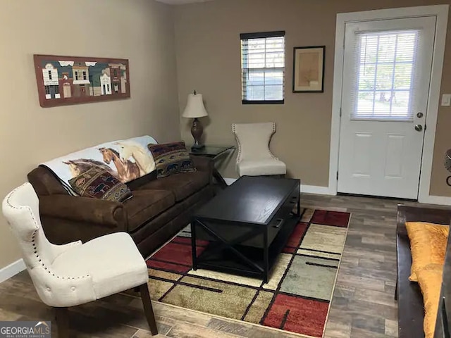 living area with baseboards and wood finished floors