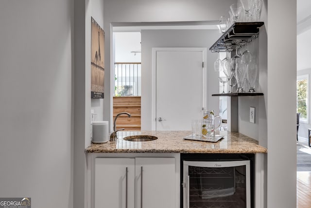 bar featuring a sink, wine cooler, and wet bar