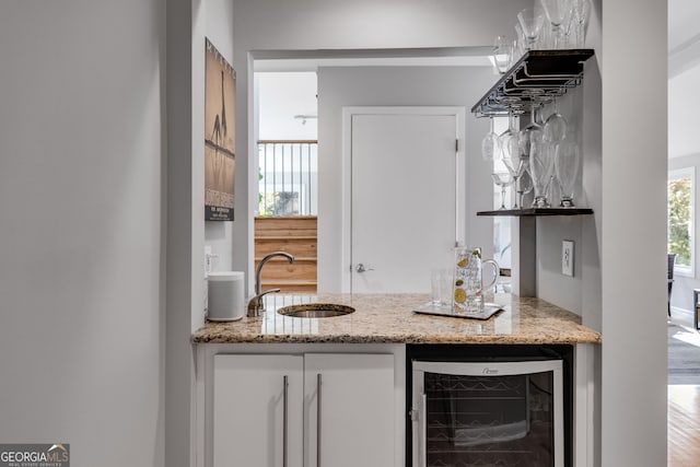bar featuring indoor wet bar, a sink, and wine cooler