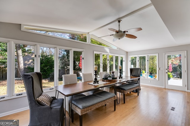 sunroom / solarium with visible vents, lofted ceiling with beams, and a ceiling fan