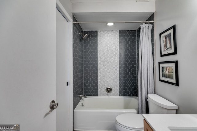bathroom featuring vanity, shower / bath combination with curtain, and toilet