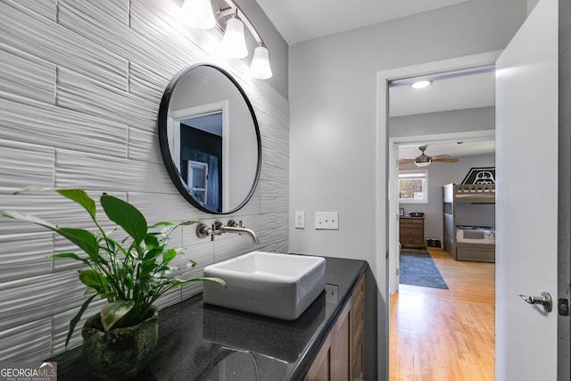 bathroom with ceiling fan, wood finished floors, and vanity