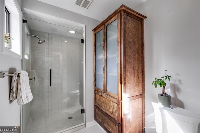 full bath featuring toilet, visible vents, and a shower stall