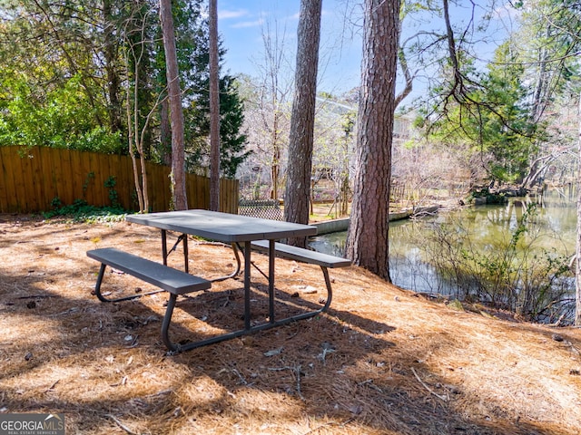 view of yard featuring a water view and fence