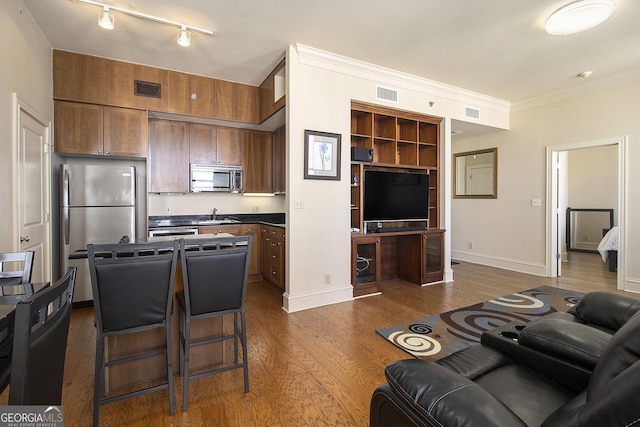 kitchen with visible vents, appliances with stainless steel finishes, dark wood-type flooring, and ornamental molding