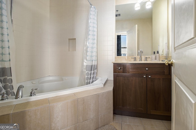 bathroom with tile patterned floors, tiled shower / bath combo, and vanity