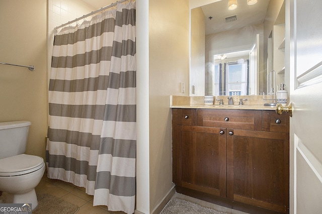 bathroom featuring vanity, a shower with shower curtain, visible vents, tile patterned floors, and toilet