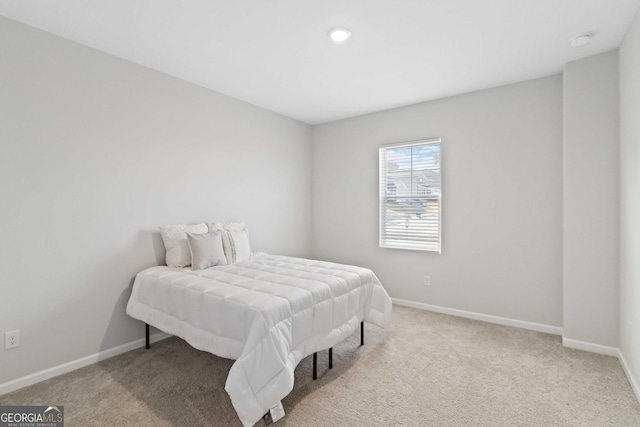 carpeted bedroom with baseboards