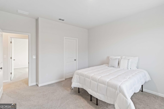 carpeted bedroom featuring visible vents and baseboards