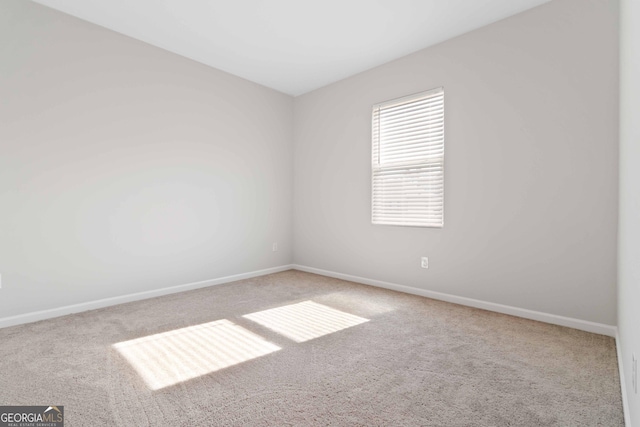 carpeted empty room with baseboards