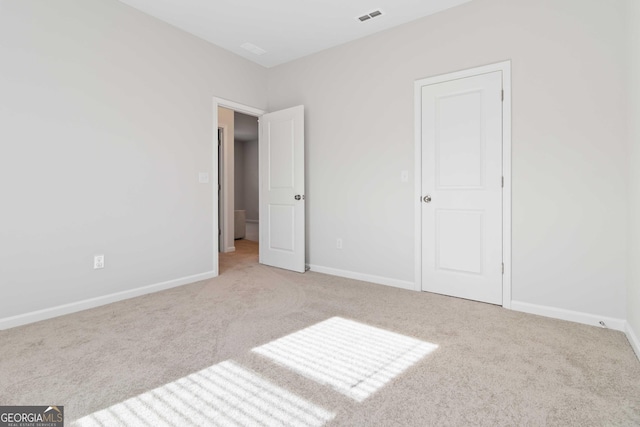 unfurnished bedroom featuring visible vents, baseboards, and carpet